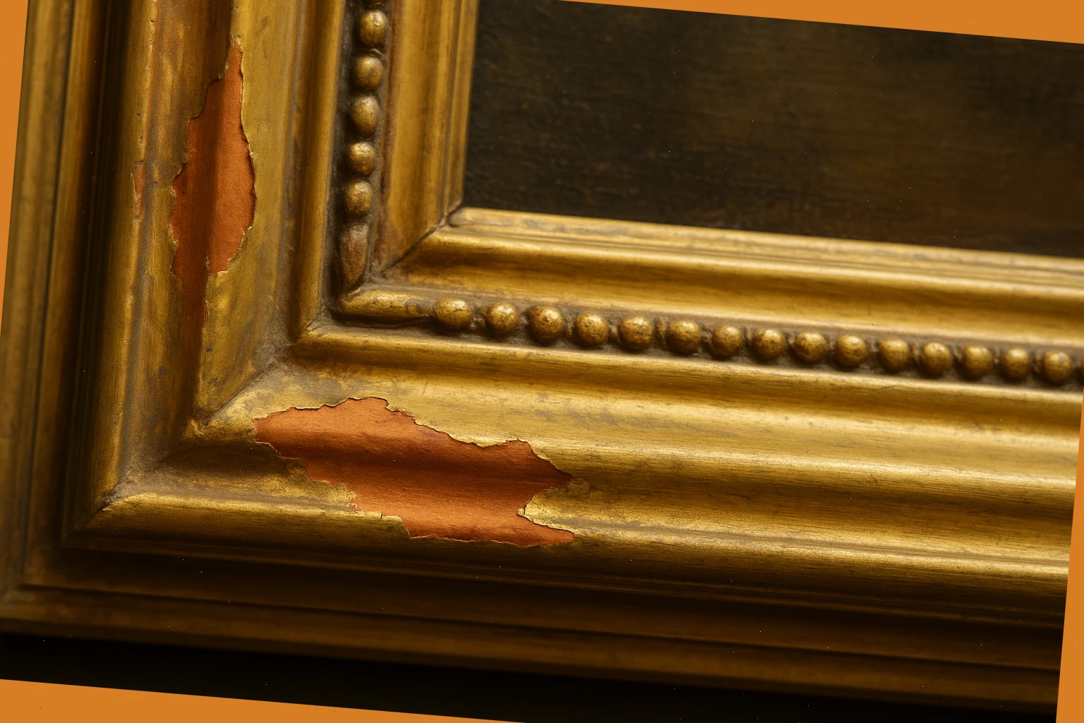 Gilded frame corner with bole exposed, ready for leaf repairs and toning